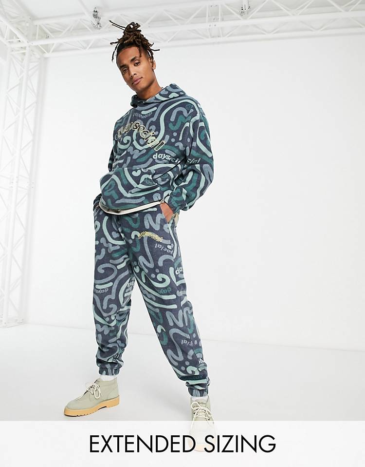 ASOS Daysocial relaxed sweatpants in polar fleece with all over doodle print in navy - part of a set